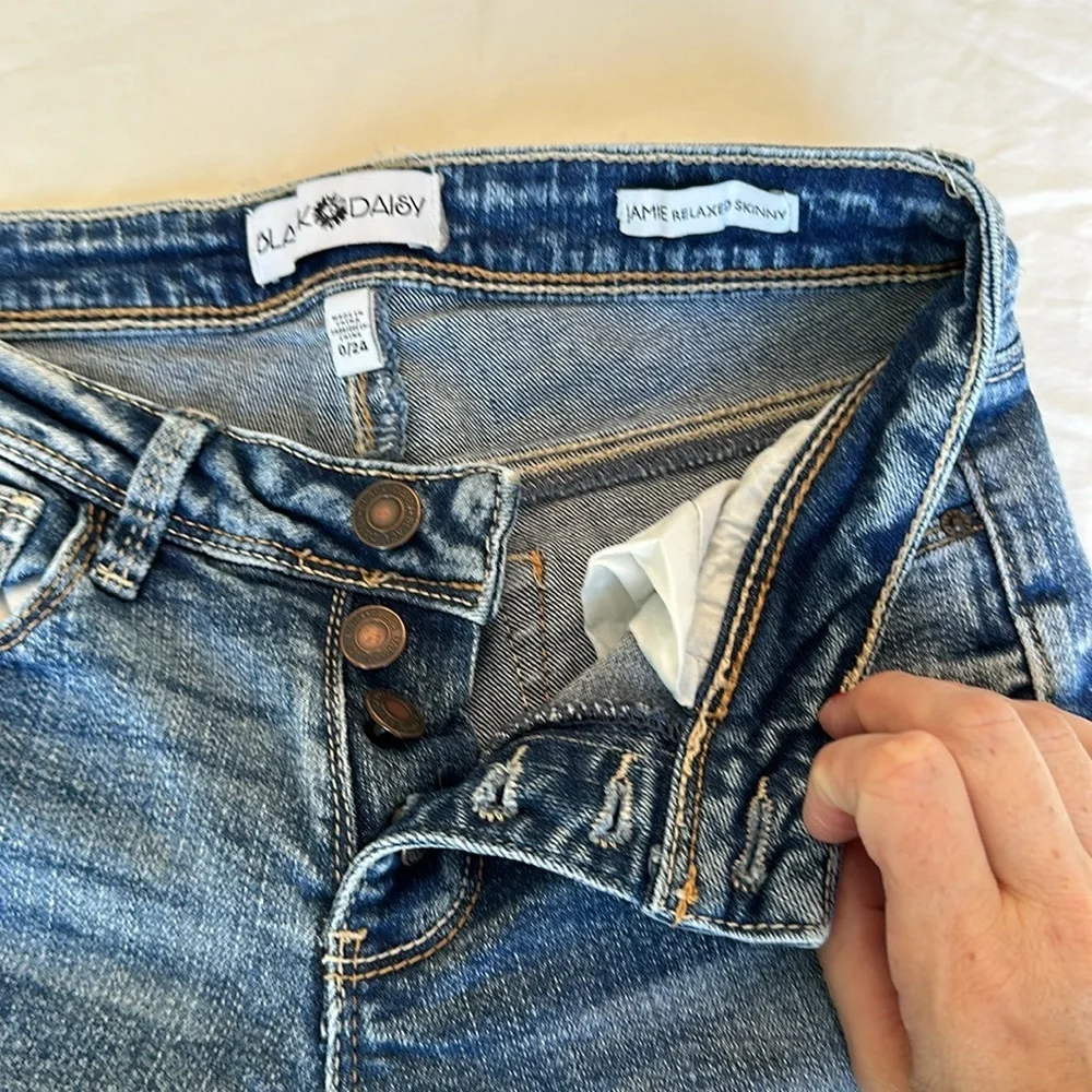 Black Daisy jeans with gem embellishments and rips w/ silver lining 26.5” inseam
